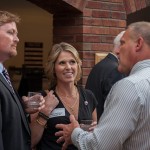 Athletic director Jeff Swenson '79 with Greg '91 and Molly (Fochtman) '92 Schnagl.